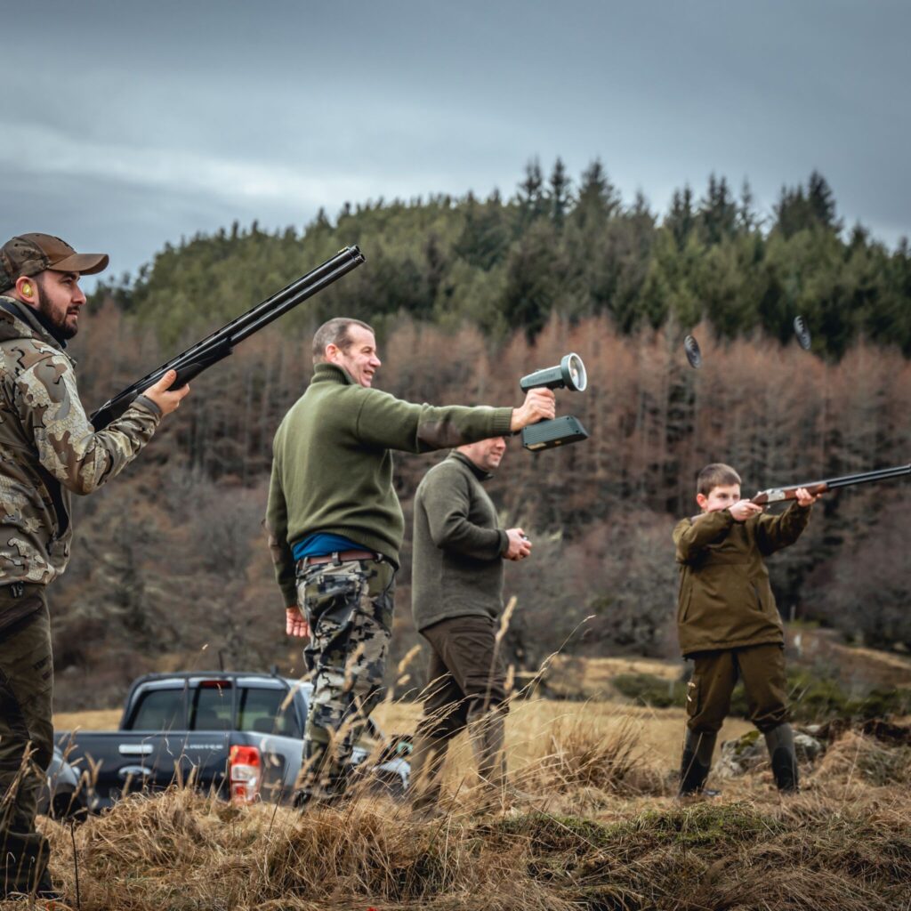 Men shooting clay pigeons using the trapmaster